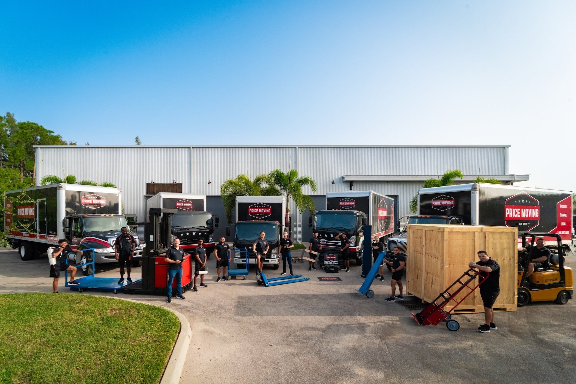 Price Moving team posing in front of the warehouse