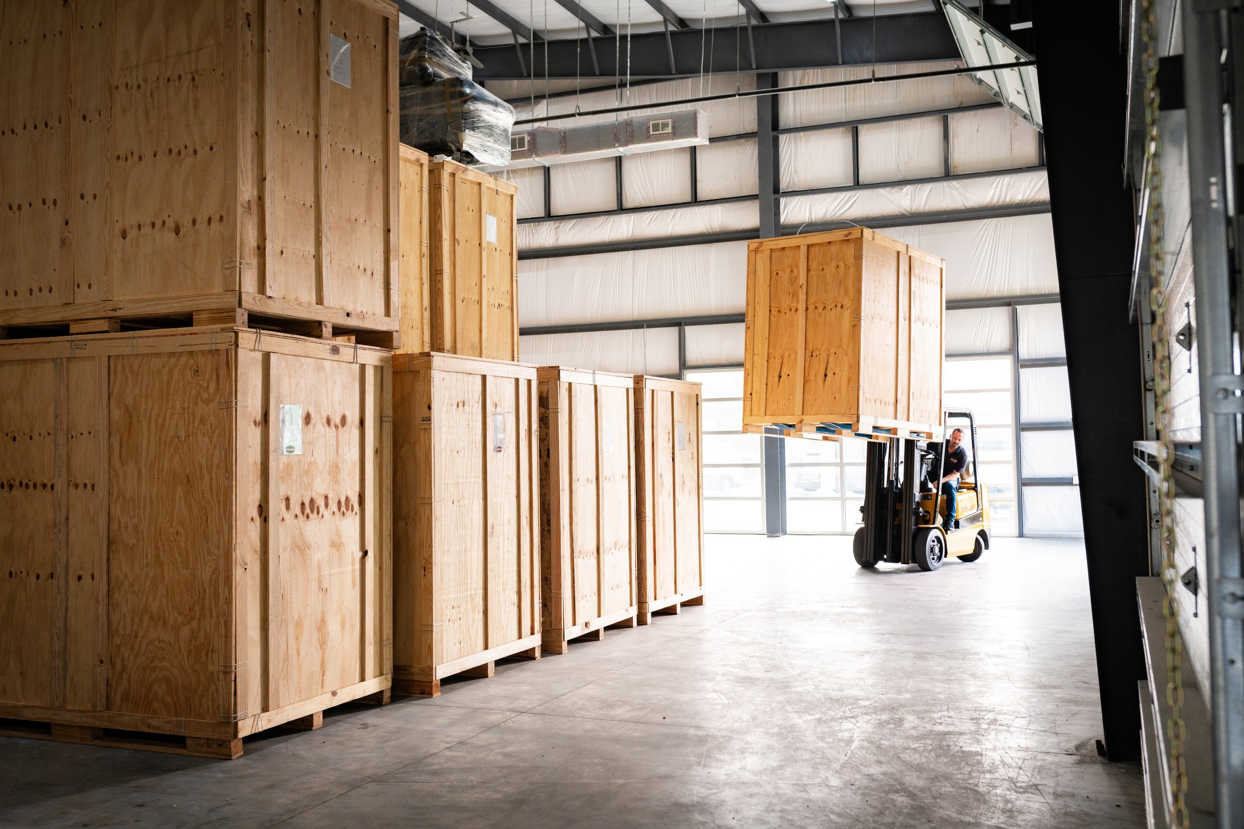 Forklift moving a large commercial crate